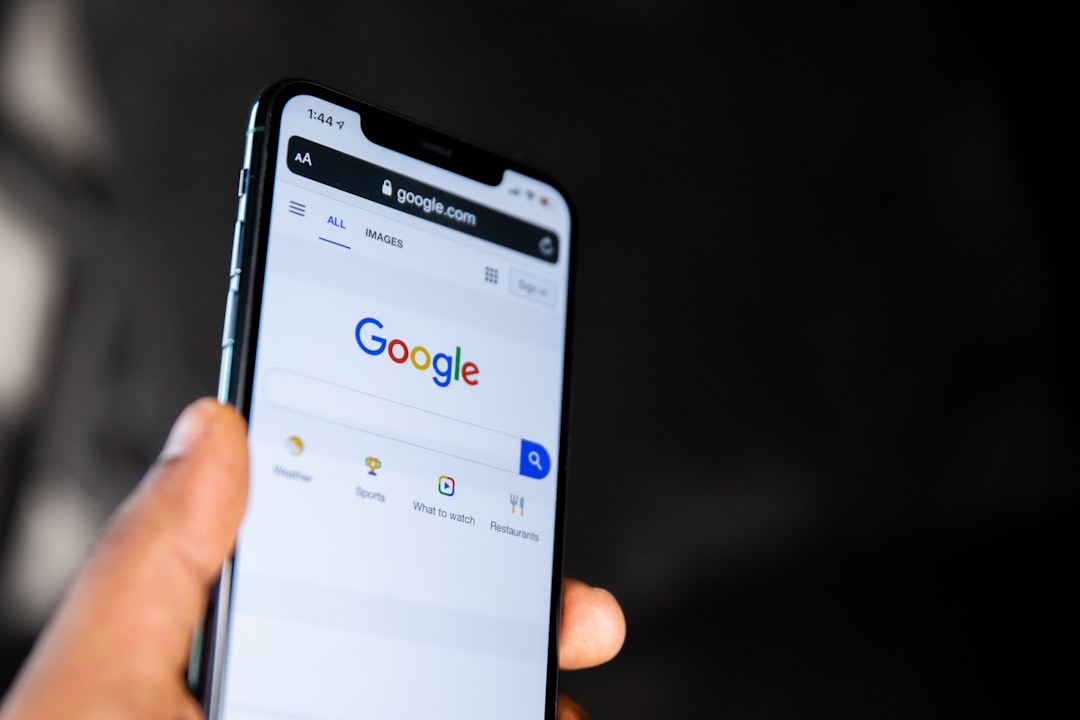 person holding black smartphone with google on screen OWC SEM services